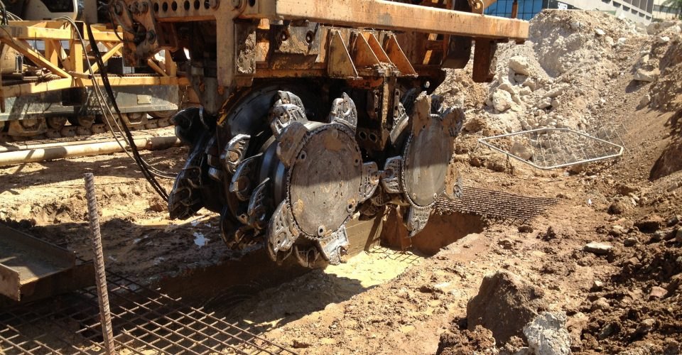 Rock trenching machine cutting through excavation